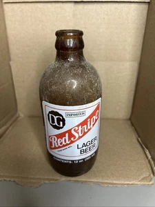 Vintage ACL DG RED STRIPE 12 Oz. Lager Bierflasche Braunglas ohne Deckel leer - Bild 1 von 3