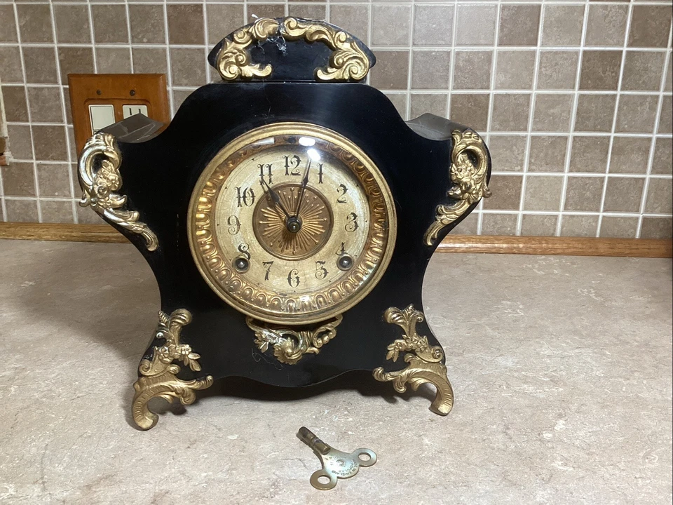 Antiguo reloj de repisa de hierro Ansonia. "11"" de alto, campanas en hora + 1/2 hora de trabajo" Foto 1 de 4