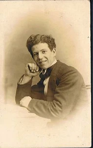 STUDIO RP POSTCARD EDWARDIAN YOUNG MAN LEANING ON CLASSICAL PILLAR C1912 - Picture 1 of 2