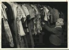 1987 Press Photo Alice Blair examines clothes at United Church of Christ