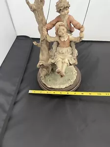 Figura B. Merli - Florencia - Firmada - Niño y niña en un columpio - Imagen 1 de 11