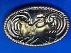 Small Oval Saddle Bronc Rodeo Cowboy On Ornate Two Tone Belt Buckle
