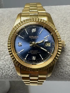 Orologio donna Gruen 321-2015 batteria nuova 26MM 6,75" tono oro quadrante blu S76 - Foto 1 di 9