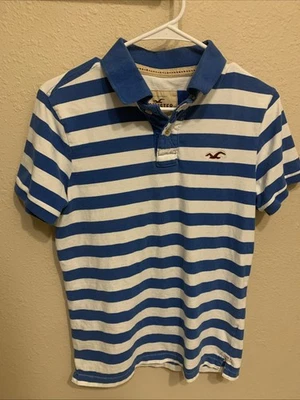 L@@K- Polo Hollister a Rayas Azul y Blanco Adolescentes Niños Talla Mediana Foto 1 de 4