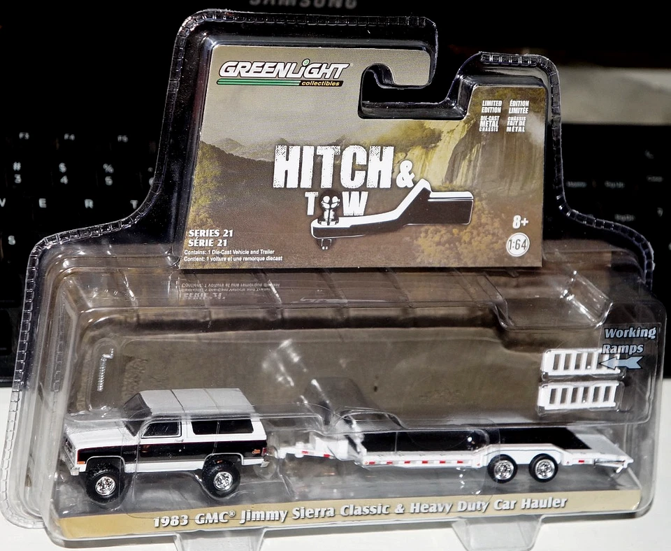1/64 GREENLIGHT HITCH & TOW 1983 GMC JIMMY SIERRA CLASSIC & HD CAR HAULER - Image 1 of 1