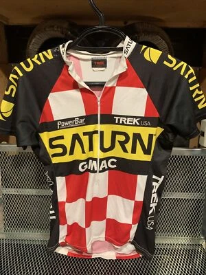 Camiseta deportiva del equipo de ciclismo Saturn Trek EE. UU. pequeña barra eléctrica GMAC muestra desgaste ver fotos Foto 1 de 4