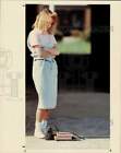 1991 Press Photo Jennifer May stares at her bag and books on the ground