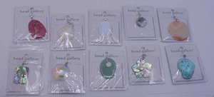 LOT OF 10 BEAD GALLERY PENDANTS, NEW IN PACKAGE, MIXED MATERIAL, STONE,  ABALONE - Picture 1 of 9