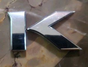 Nissan Juke Emblem Symbol Sign Badge Logo Ornament Oe Genuine Wording Letter "K" - Picture 1 of 3