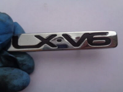 MAZDA 626 1999 6CYL TAPA TRASERA MALETERO CUBIERTA EMBLEMA INSIGNIA CALCOMANÍA SIGNO SÍMBOLO LX-V6 OEM Foto 1 de 3