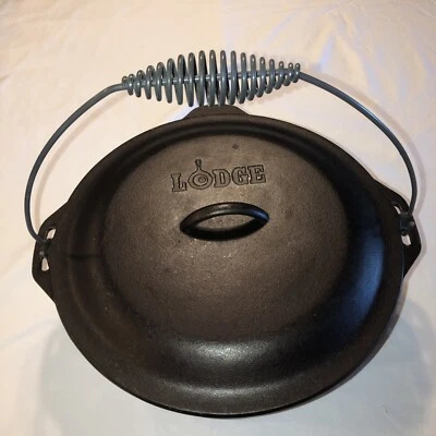 HORNO HOLANDÉS DE HIERRO FUNDIDO LODGE #12DO TAPA AUTO-BASTING Y CABLE DE FIANZA EE. UU. Foto 1 de 4