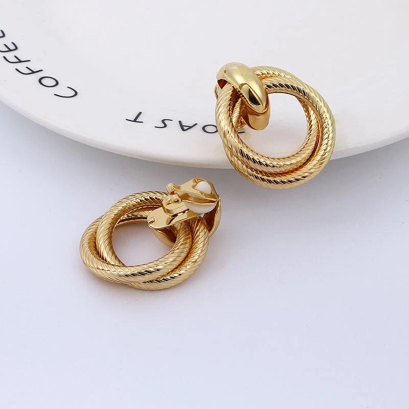 Clip on 1 1/2" gold textured loose knot button style earrings - Image 1 of 2