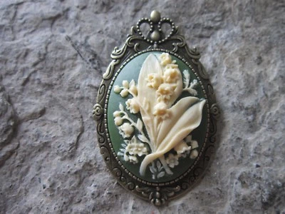 2 EN 1 - BROCHE/COLGANTE CAMAFEO LIRIO DEL VALLE BRONCE - FLOR - CREMA Foto 1 de 2