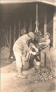 RPPC Father & Son De-feathering Turkey in Barn early 1900s - Picture 1 of 2