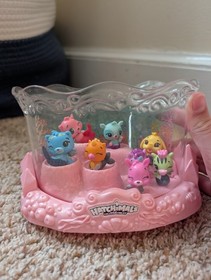 Hatchimals collectibles Pink/Clear Display Case with 8 color changing figures.