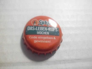 Gebrauchter, orange-grüner Kronkorken Lübzer DAS-LEBEN-RUFT-WOCHEN (mit Code) - Bild 1 von 1