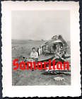 I7/25 WW2 ORIGINAL PHOTO OF GERMAN WEHRMACHT LW AIRMAN SITS ON WRECKED PLANE