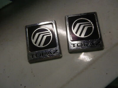1984 1985 MERCURY TOPAZ ROOF PILLAR EMBLEMS - Image 1 of 3
