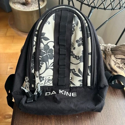Dakine Cosmo 6.5L backpack with a black and white floral patter - Image 1 of 4