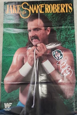 Póster WWF/WWE 21x32 firmado por Jake "La Serpiente" Roberts con pegatina Foto 1 de 4