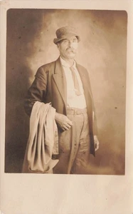 RPPC MAN  OVERCOAT RUMPLED CLOTHES AND SHORT NECKTIE c1910 POSTCARD 113025 U - Picture 1 of 2