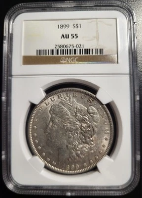 1899 P Morgan $1 Silver Dollar. NGC AU 55 - Image 1 of 2