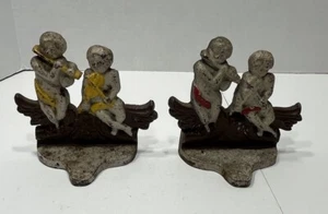 Sujetalibros de hierro fundido pintados vintage querubines instrumentos de juego - Imagen 1 de 11