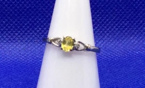 A Nine Carat Gold Ring with a central yellow Sapphire & a Diamond on each side. - Picture 1 of 7