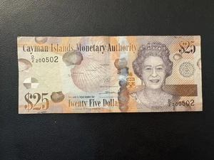 Billete de 25 dólares 2014 de las Islas Caimán Reina Isabel II QE2 - Imagen 1 de 3