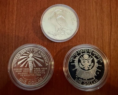 1991 MOUNT RUSHMORE  $1 SILVER DOLLAR, 1986 $1 STATUE OF LIBERTY,  1984 OLYMPIC - Image 1 of 3