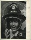 Press Photo Child tries on fire uniform at Jonesville, New York fire department