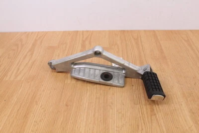 1984 HONDA CB650SC NIGHTHAWK 650 Left Rear Footpeg, Foot Peg, Rest with Bracket - Image 1 of 4