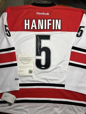 Noah Hanifin Autographed WhiteReebok Premier Jersey Carolina Hurricanes UDA COA - Image 1 of 4