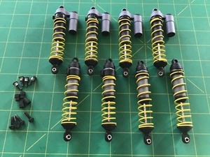 Tmaxx shocks 8 with RC Raven dual rate Team Associated fake piggyback Emaxx too - Picture 1 of 7