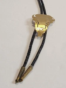 VINTAGE WILD BRYDE GOLD TONE 2D BISON HEAD BOLO TIE BLACK BRAID CORD - Picture 1 of 13