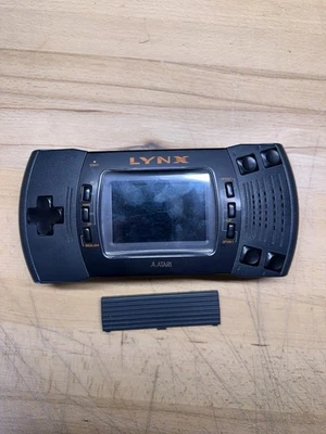 Sistema de consola Atari Lynx II 2 para piezas o reparación con cubierta de batería Foto 1 de 3
