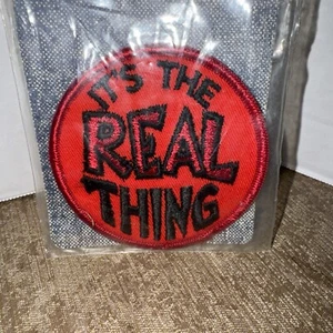 Vtg Sew On Patch “IT’S THE REAL THING”  Red And black NOS - Picture 1 of 3