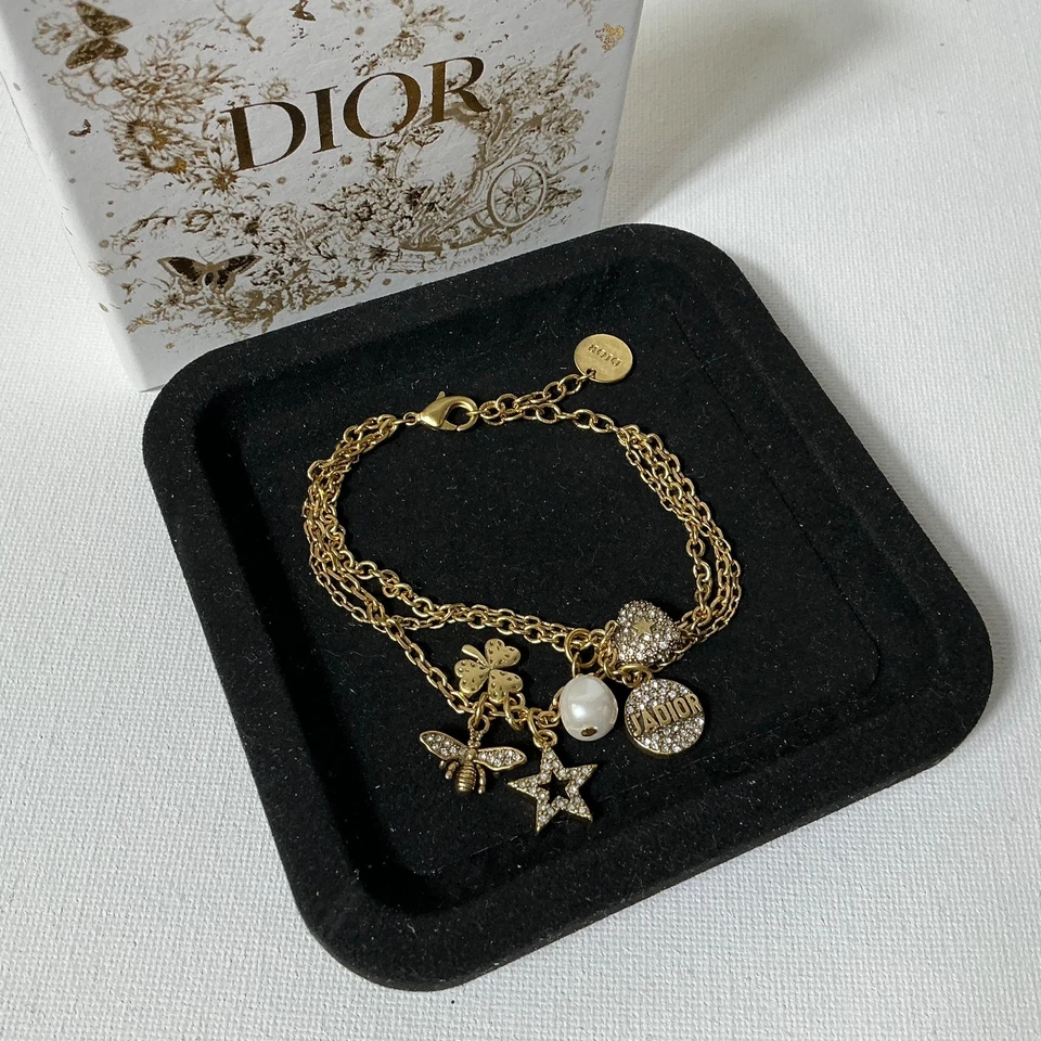 Pulsera con logotipo dorado Dior con caja Foto 1 de 3