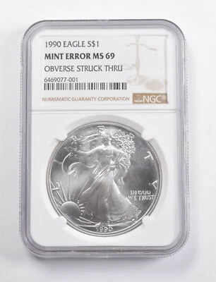 Mint Error MS69 1990 American Silver Eagle OBV Struck Thru NGC *3458 - Image 1 of 3