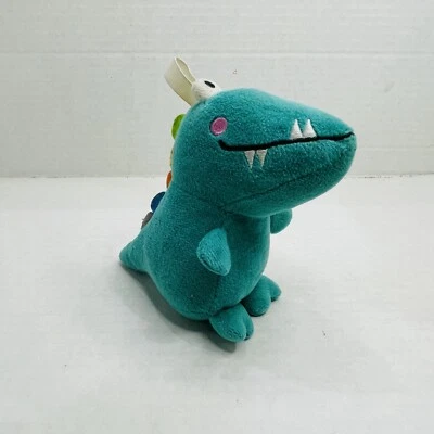 Green Plush Rattle Mini Dinosaur With Hang Ribbon To Attach Colorful Spikes - Image 1 of 4