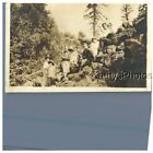 FOUND B&amp;W PHOTO G_8900 MEN AND WOMEN SITTING ON A ROCKY SLOPE IN WOODED AREA