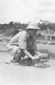 The headman of a tin mine in Malaya picking up tin ore 1957 Old Photo - Picture 1 of 1