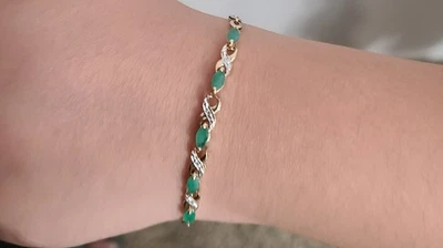 10K gold tennis bracelet with natural emeralds and diamonds - Image 1 of 4