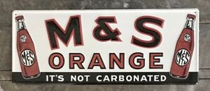 M & S ORANGE Soda “It’s Not Carbonated” Embossed Metal Sign, 9.5” x 23”
