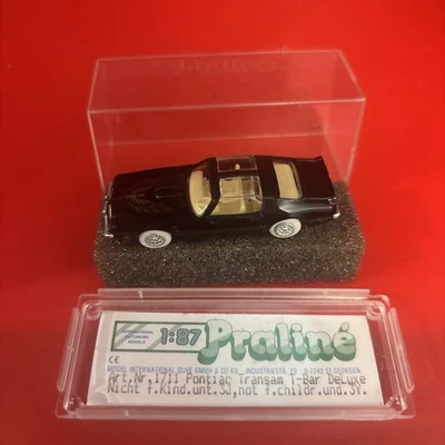 Pontiac Trans Am PRALINE HO 1/87 con tapas en T con CAJA HECHA EN ALEMANIA negro/dorado Foto 1 de 4