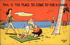 Comic Pun changing baby diaper at beach ~ 1950-60s vintage postcard