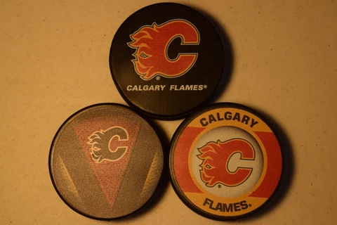 Calgary Flames Hat Trick Three Official NHL Licensed Pucks  Basic-Stitch-Retro Cover