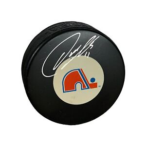 Owen Nolan Autographed Hockey Puck (Quebec Nordiques)