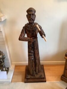 An unusual vintage tall stained pine hand carved statue of a monk or priest