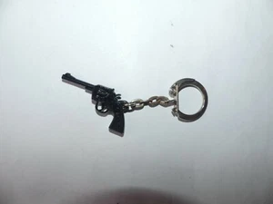 PORTE CLÉ PLASTIQUE FIGURINE JOUET PISTOLET NOIR SCHICK - Picture 1 of 1